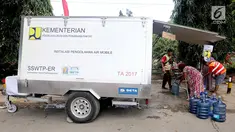 Sebuah mobil instalasi pengolahan air Kementerian PUPR mendistribusikan air untuk kebutuhan pengungsi korban gempa dan tsunami Palu di halaman kantor Wali Kota Palu, Sulawesi Tengah, Senin (8/10). (Liputan6.com/Fery Pradolo)