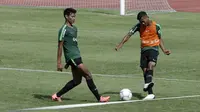 Pemain Timnas Indonesia U-22, Anan Lestaluhu, berebut bola dengan Septian Bagaskara saat latihan di Stadion Madya, Jakarta, Kamis (17/1). Latihan ini merupakan persiapan jelang Piala AFF U-22. (Bola.com/Yoppy Renato)