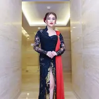 Ayu Ting Ting tampil elegan dan glamor saat memadukan kebaya berpotongan asimetris dan sampiran kain tulle di bahu. Selaras dengan bawahan batik beraksen front slit. (Instagram/ayutingting92).