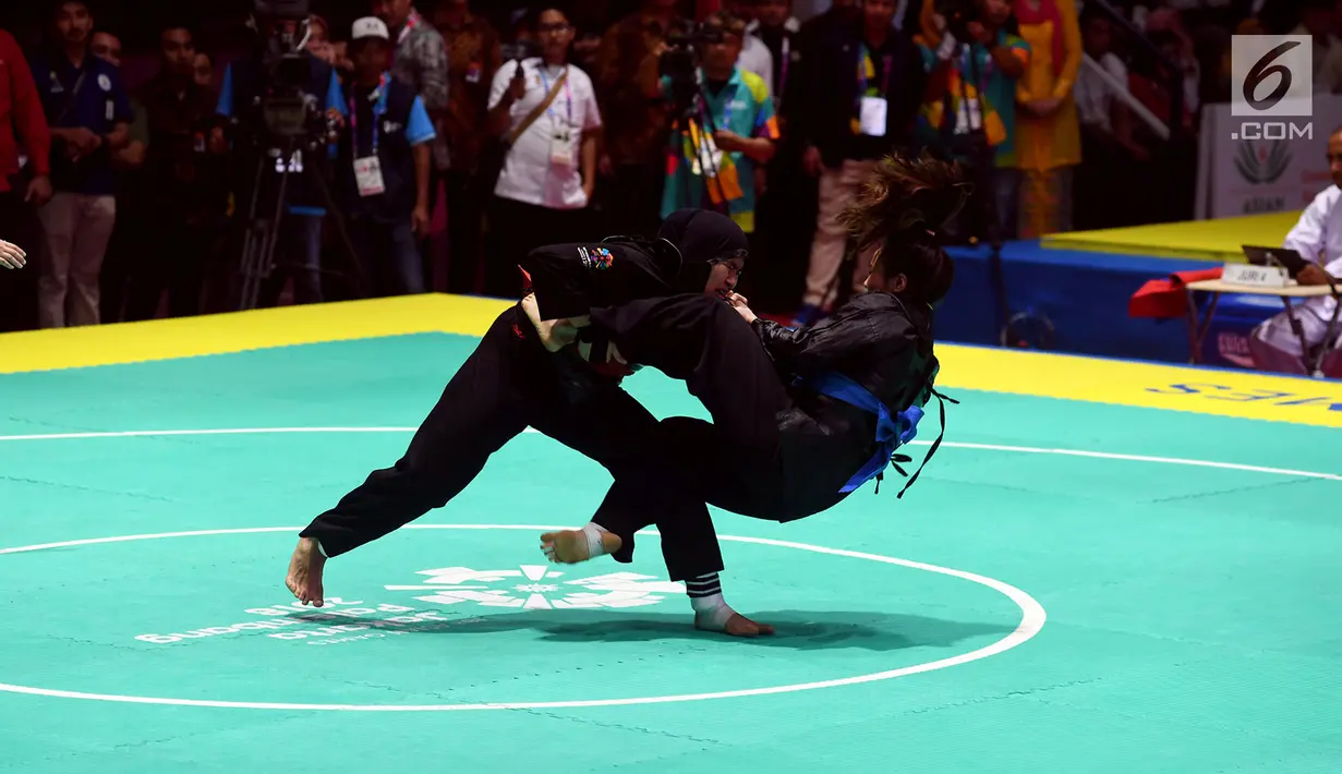 Pesilat Indonesia Pipiet Kamelia bertarung melawan Thi Cam Nhi Nguyen dari Vietnam pada final nomor 60-65 kg putri pencak silat Asian Games 2018 di Padepokan Pencak Silat TMII, Jakarta, Rabu (29/8). Pipiet menang 5-0. (Merdeka.com/Imam Buhori)