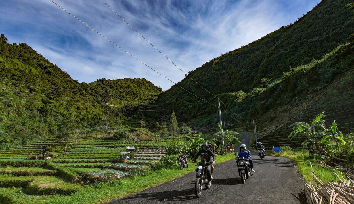Warga melintasi kawasan pegunungan yang dijuluki "Swiss van Java" di sekitar Desa Wisata Sembungan, Wonosobo, Jawa Tengah, Senin (7/4/2025). (merdeka.com/Arie Basuki