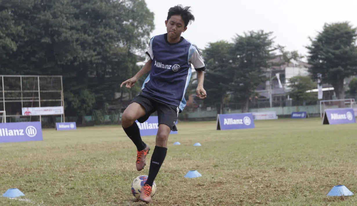 Seorang anak mengikuti coaching clinic bersama legenda Bayern Munchen, Martin Demichelis, di Lapangan PSPT Tebet, Jakarta, Minggu (23/6). Acara ini merupakan rangkaian Allianz Explorer Camp 2019. (Bola.com/Vitalis Yogi Trisna)
