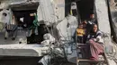 Bantuan ini merupakan bagian dari rencana tanggap darurat 60 hari di tengah meningkatnya serangan militer Israel di wilayah tersebut. Tampak dalam foto, sebuah keluarga Palestina memandang ke bawah dari rumah mereka yang rusak parah di Jabalia, di bagian utara Jalur Gaza, pada Jumat 7 November 2025. (Omar AL-QATTAA/AFP)