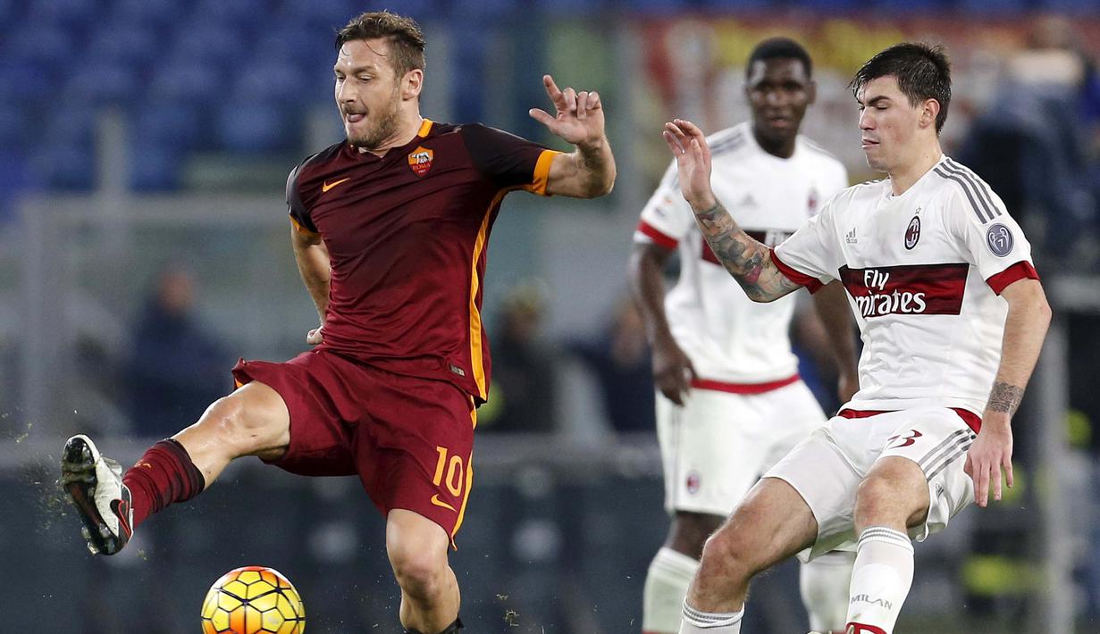 Pemain AC Milan, Alessio Romagnoli (kanan) berebut bola dengan Kapten AS Roma, Francesco Totti   pada lanjutan Liga Italia Serie A di Stadion Olympico, Roma, Minggu (10/1/2016) dini hari WIB.     (REUTERS/Giampiero Sposito)
