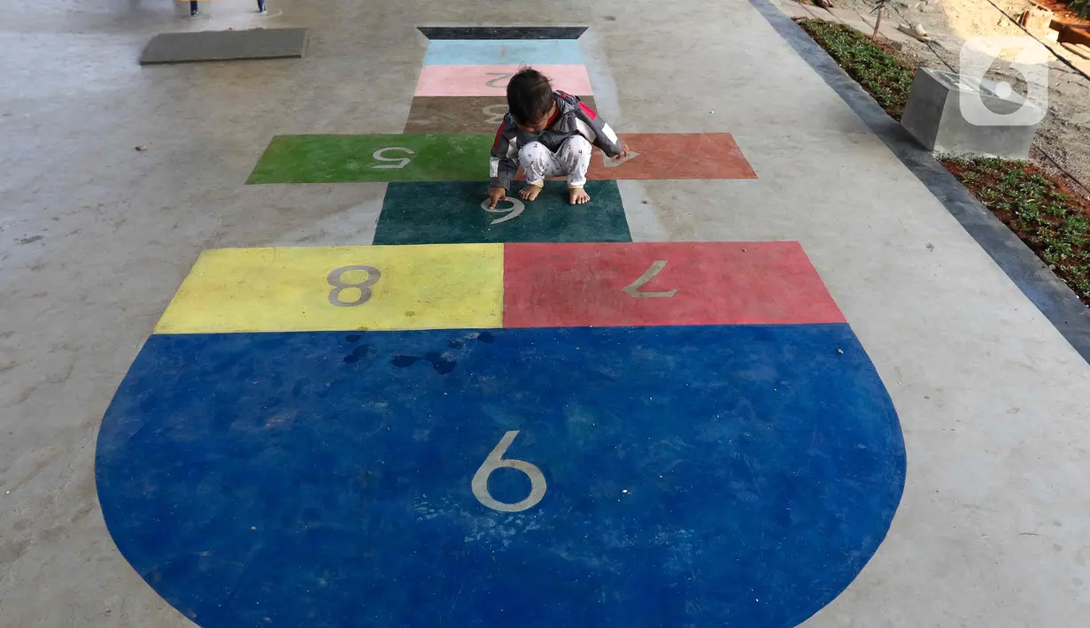Seorang anak bermain permainan tradisional di Taman Interaksi, kolong Tol Becakayu, kawasan Cipinang Melayu, Jakarta, Selasa (31/10/2023). (Liputan6.com/Herman Zakharia)