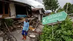 Seorang pria berjalan di samping rumah-rumah yang rusak setelah pergerakan tanah melanda permukiman mereka di desa Padasari, Tegal, Jawa Tengah, Senin 9 Februari 2026. Fenomena tanah bergerak di Desa Padasari, Kecamatan Jatinegara, Kabupaten Tegal, Jawa Tengah masih terus terjadi. (DEVI RAHMAN/AFP)