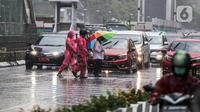Pejalan kaki yang menggunakan payung saat hujan deras menyeberang jalan di kawasan Thamrin, Jakarta, Rabu (23/11/2022). Sejak Oktober, DKI Jakarta mulai memasuki musim penghujan yang sudah masuk ke dalam tahap ekstrem. (Liputan6.com/Faizal Fanani)