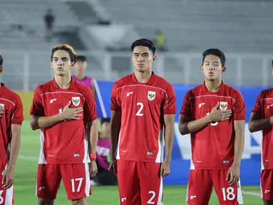 Bek Timnas Indonesia U-22, Muhammad Ferrari, tampil beda dengan rekan setimnya saat menyanyikan lagu Indonesia Raya pada Laga uji coba melawan India di Stadion Madya, Jakarta, Jumat (10/10/2025). (Bola.com/M Iqbal Ichsan)