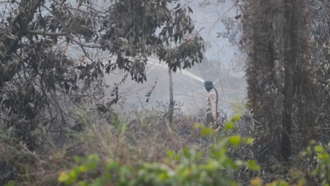 Personel Satgas Karhutla Riau berusaha memadamkan sisa kebakaran lahan agar tidak menimbulkan kabut asap.