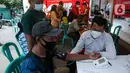 Petugas melakukan screening terhadap penerima vaksin COVID-19 di Pasar Gang Kancil, Jakarta Barat, Senin (2/8/2021). Gubernur Anies Baswedan mengatakan pemprov DKI telah memenuhi target Presiden Joko Widodo untuk menyalurkan vaksinasi dosis pertama kepada 7,5 juta orang. (Liputan6.com/Faizal Fanani)