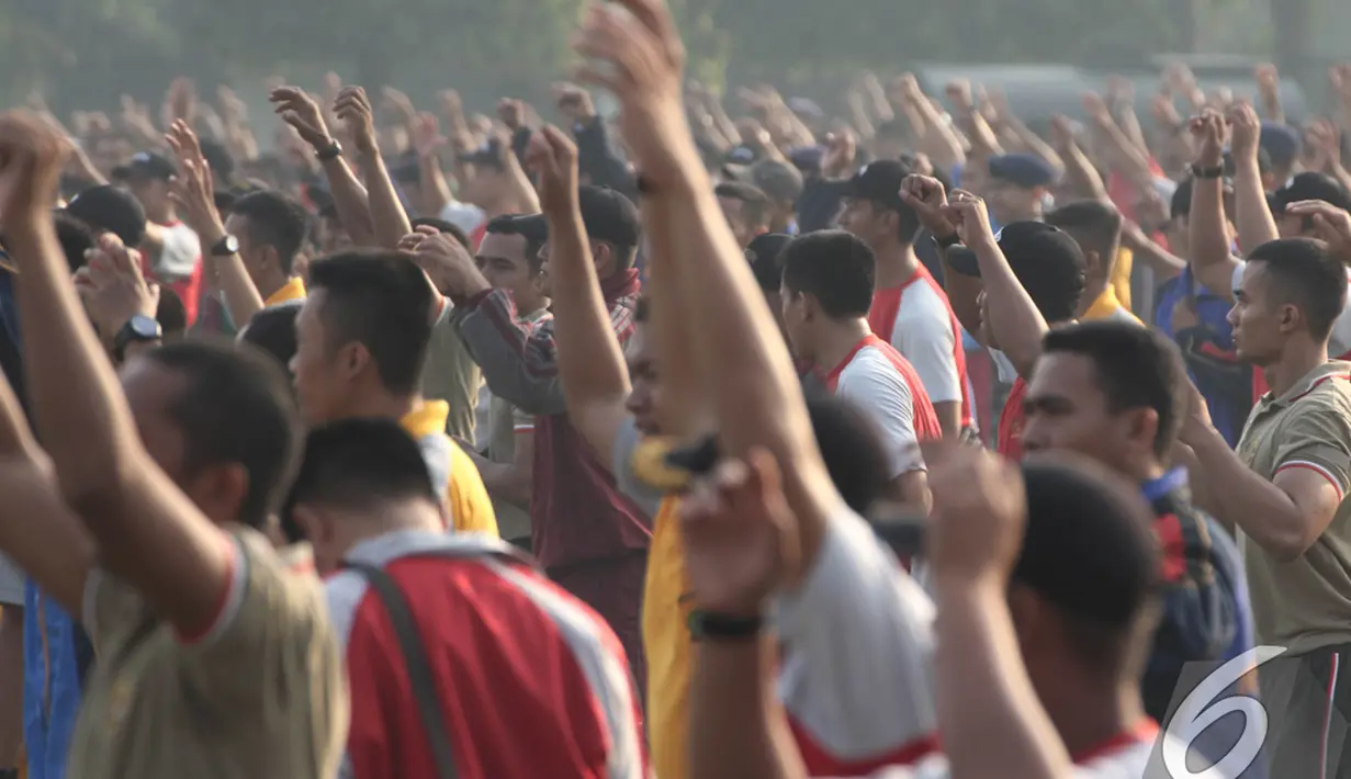 Ratusan anggota gabungan TNI dan Polri mengikuti gerakan instruktur saat senam bersama di Lapangan Utama Mako Kopassus, Cijantung, Jakarta, Jumat (21/11/2014). (Liputan6.com/Herman Zakharia)