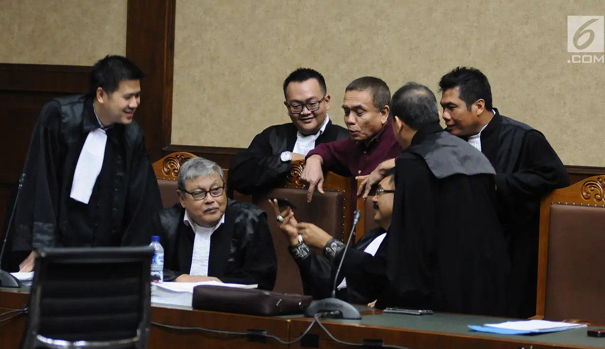 Gubernur non-aktif Aceh Irwandi Yusuf  berbincang dengan kuasa hukumnya saat menjalani sidang lanjutan di Pengadilan Tipikor, Jakarta, Senin (18/3). Sidang lanjutan dengan agenda pemeriksaan terdakwa dan saksi. (Liputan6.com/Herman Zakharia)