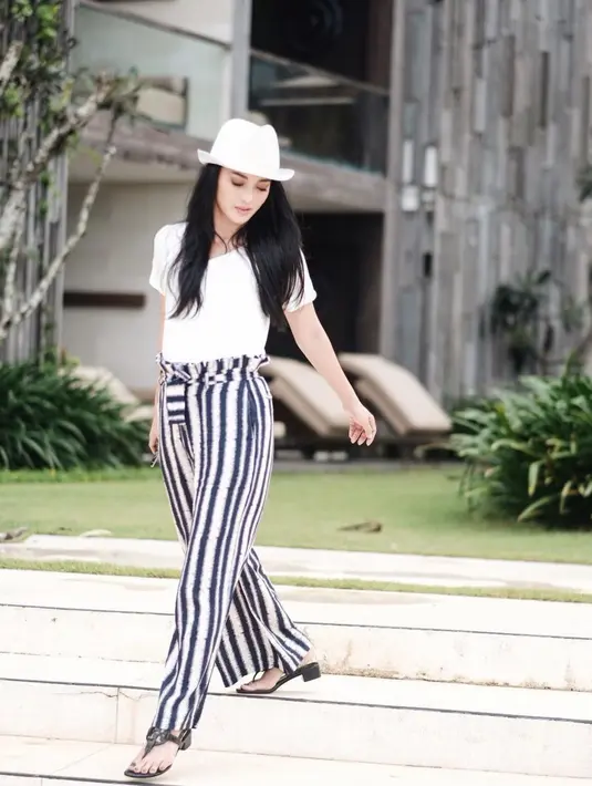Saat liburan, topi memang menjadi fashion item wajib bagi wanita kelahiran 11 November 1982 ini. Selain itu, ia juga kerap memadukannya dengan kacamata berwarna hitam. (Liputan6.com/IG/ririnekawati)