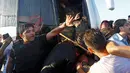 Warga membawa kayu untuk mengarahkan pukuannya ke para tentara yang masuk kedalam bus di Jembatan Bosphorus, Istanbul , Turki, (16/7). Tentara berebutan masuk kedalam bus untuk menyelamatkan diri dari pukulan warga. (REUTERS / Murad Sezer)