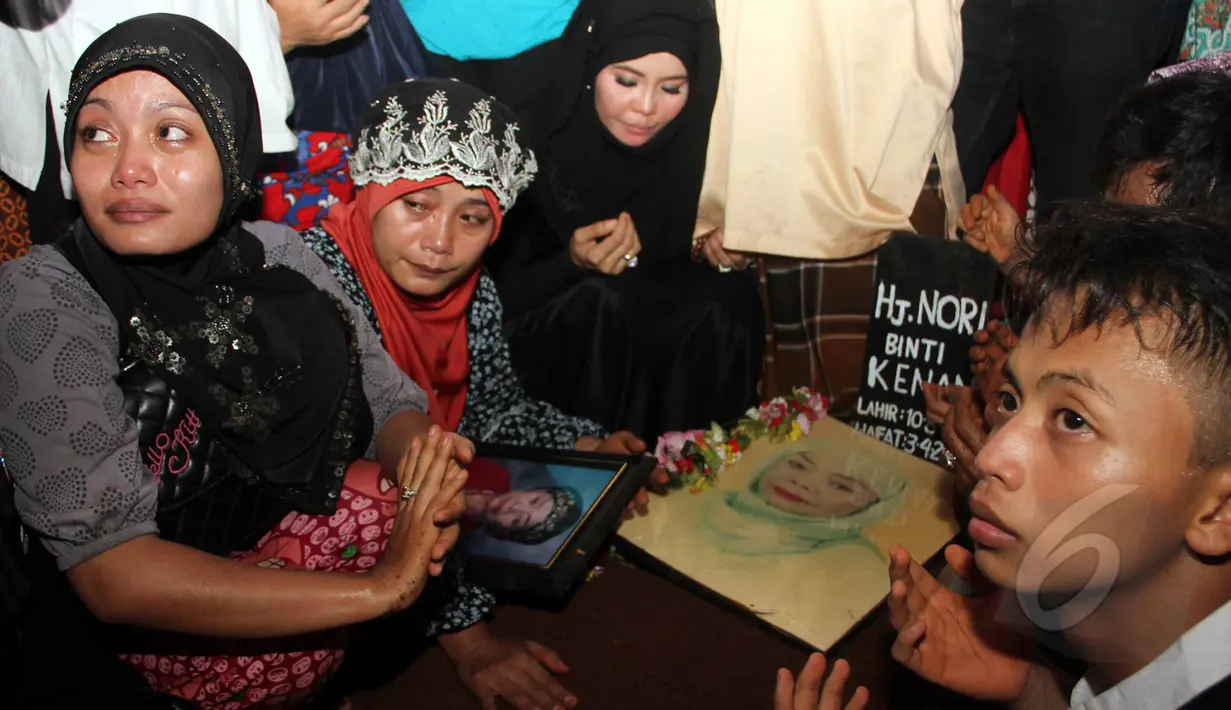 Keluarga dan sahabat saat mendoakan komedian Betawi Nur Sarinuri atau lebih dikenal Mpok Nori seusai dimakamkan di TPU Pondok Ranggon, Jakarta Timur, Jumat (3/4/2015). (Liputan6.com/Helmi Afandi)
