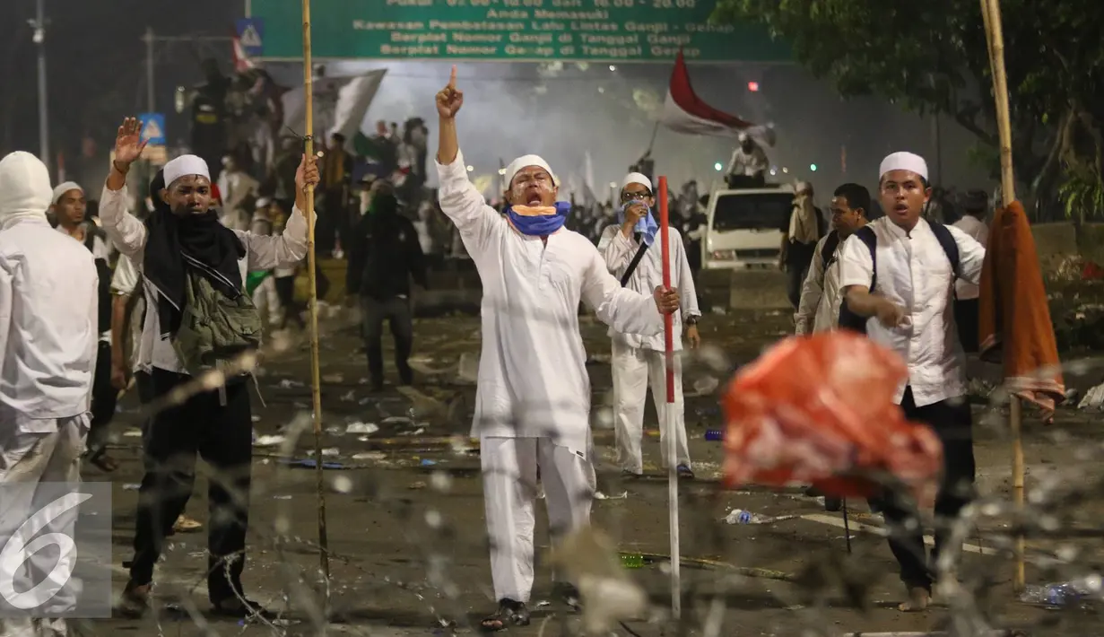 Pendemo berteriak saat polisi menyerang mereka dengan gas air mata, Jakarta, Jumat (4/11). Diduga bentrok terjadi saat massa HMI menyerang polisi dan polisi membalasnya dengan melempar gas air mata. (Liputan6.com/Immanuel Antonius)