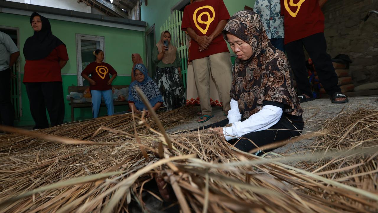 Para perajin di Desa Tamansuruh Banyuwangi menganyam ilalang jadi  atap rumah (Istimewa)