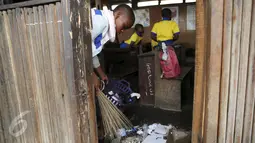 Seorang siswa membersihkan ruang belajarnya di sekolah terapung, Lagos Lagoon, Nigeria (29/2/2016). Sekolah ini adalah sekolah yang dibangun di atas air di Makoko, sebuah kawasan padat penduduk di Lagos, ibukota Nigeria. (Reuters/Akintunde Akinleye)