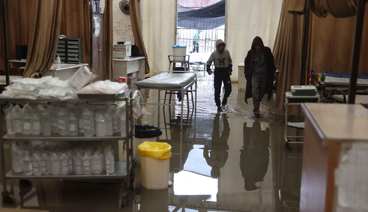 Genangan air menutupi lantai tenda darurat milik Rumah Sakit Nasser, yang berfungsi sebagai tempat penerimaan pasien rawat jalan dan departemen gawat darurat, setelah hujan lebat di Khan Yunis di Jalur Gaza selatan pada 26 Maret 2026. Hujan deras yang mengguyur Khan Yunis, Gaza Selatan, pada Kamis 26 Maret 2026, memicu banjir yang merendam tenda darurat milik Rumah Sakit Nasser. (Bashar Taleb/AFP)