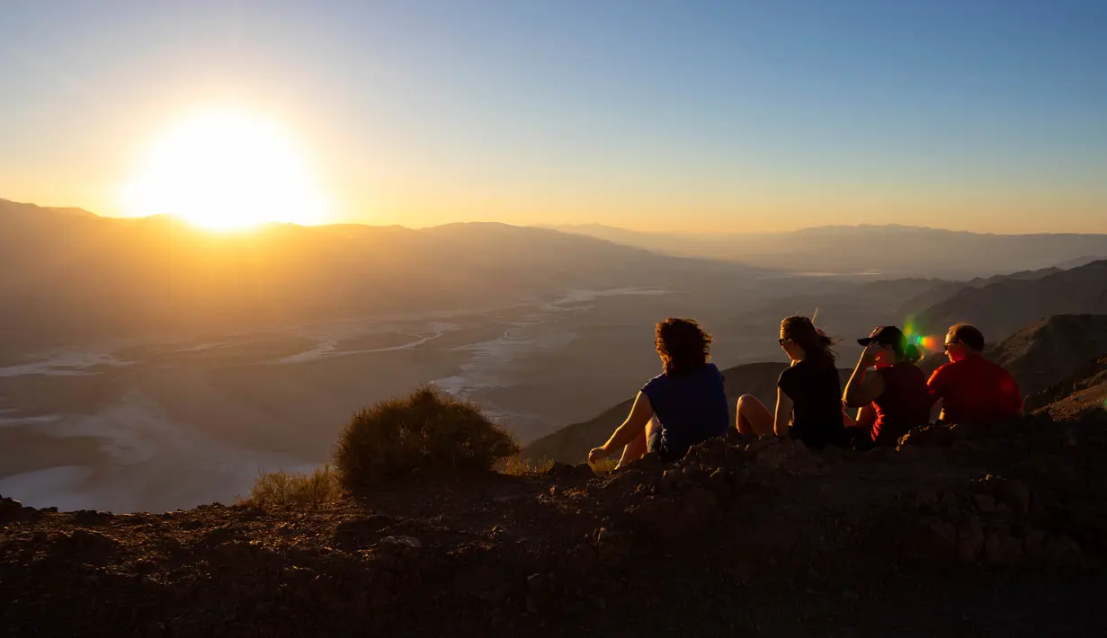 <p>Para pengunjung menyaksikan matahari terbenam di Taman Nasional Death Valley, California, Amerika Serikat, 11 Juli 2023. Juli adalah bulan terpanas di taman tersebut dengan rata-rata suhu mencapai 116 derajat (46,5 Celcius). (AP Photo/Ty ONeil)</p>