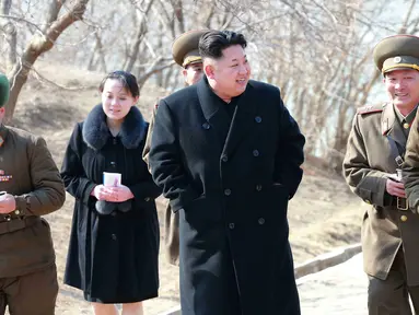 Adik Kim Jong-un, Kim Yo-Jong (kedua kiri) mendampingi kakaknya memeriksa perusahaan pertahanan Sin Islet, Kangwon, Korut 12 Maret 2015. Kim Jong-un mempromosikan Kim Yo-jong menjadi anggota politbiro Partai Pekerja yang berkuasa. (AFP Photo/KCNA via KNS)