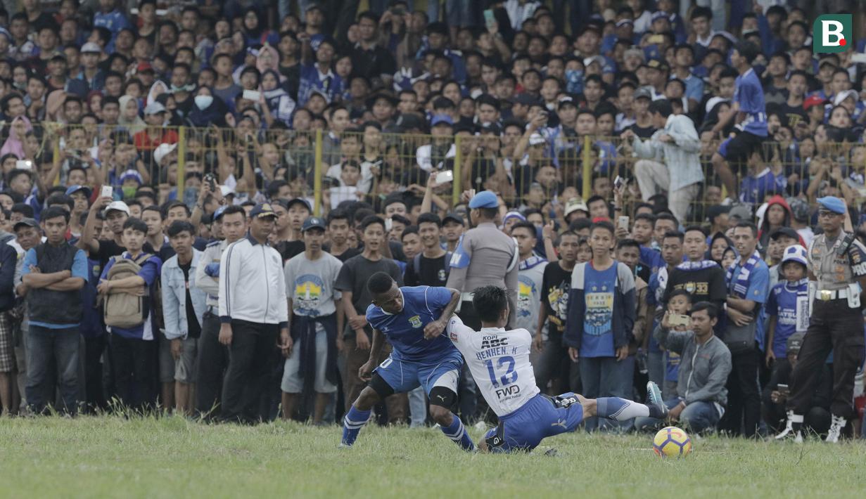 Striker Perserang Serang, Oktovianus Maniani, berusaha melewati bek Persib Bandung, Henhen Herdiana, pada laga persahabatan di Stadion Maulana Yusuf, Serang, Kamis (1/3/2018). Persib menang 6-0 atas Perserang. (Bola.com/M Iqbal Ichsan)