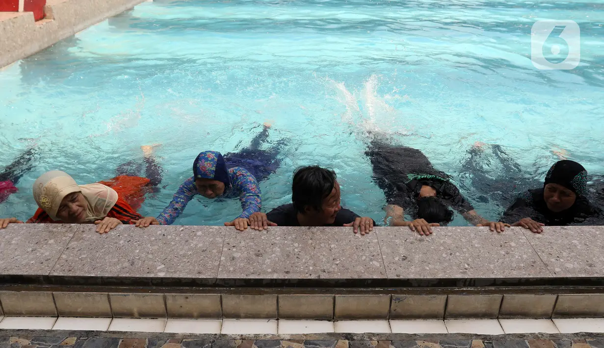 Sejumlah peserta berlatih berenang pada kegiatan Gerakan Prolanis Total (Gelato) di Gelanggang Remaja KONI, Gambir, Jakarta, Kamis (11/8/2022). Puskesmas Kecamatan Gambir mengadakan kegiatan Gelato berupa pelatihan berenang kepada peserta lansia penderita penyakit kronis untuk mencegah penyakit tersebut tambah parah. (Liputan6.com/Herman Zakharia)