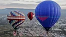 Sejumlah peserta mengikuti Festival Balon Udara Internasional XVIII di Taman Metropolitan, Leon, negara bagian Guanajuato, Meksiko pada 16 November 2019. Tak hanya balon udara biasa, banyak yang memiliki bentuk, serta warna unik menyemarakkan langit Kota Leon. (MARIO ARMAS / AFP)
