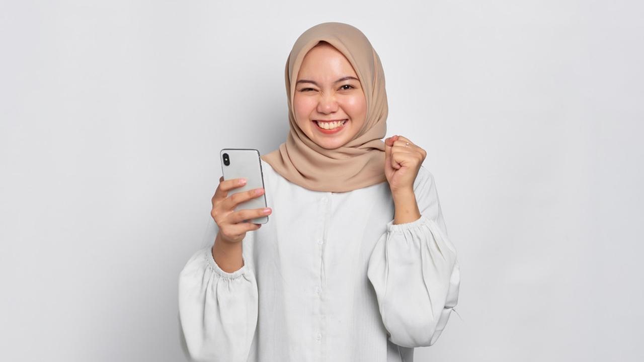 Ilustrasi wanita berhijab memegang smartphone