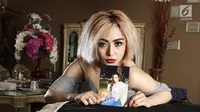 Mantan Istri Farhat Abas, Regina Andriane Saputri bespose sambil menunjukan foto di kediamannya di Bogor (12/7). Lama tak muncul, perempuan yang pernah menikah dengan Farhat Abbas itu kembali menarik perhatian. (Liputan6.com/Herman Zakharia)