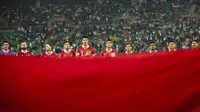 Para pemain Timnas Indonesia berdiri saat menyanyikan lagu kebangsaan Indonesia Raya pada pertandingan Kualifikasi&nbsp;Piala Dunia 2026&nbsp;zona Asia melawan&nbsp;Irak di Basra Sport City Stadium, Kamis, 16 November 2023. (HUSSEIN FALEH / AFP)