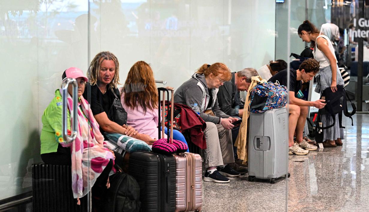 Pgs. Asst. Deputy Communication and Legal Bandara Internasional Soekarno-Hatta, Aziz Fahmi Harahap, mengatakan secara kumulatif, sejak 28 Februari hingga Senin 2 Maret 2026, total 41 penerbangan rute Timur Tengah dari dan menuju Bandara Soekarno-Hatta telah dibatalkan. Tampak dalam foto, para penumpang menunggu di tengah gangguan penerbangan akibat serangan Israel-Amerika Serikat terhadap Iran, di Bandara Internasional I Gusti Ngurah Rai, Bali, pada Senin 2 Maret 2026. (SONNY TUMBELAKA/AFP)