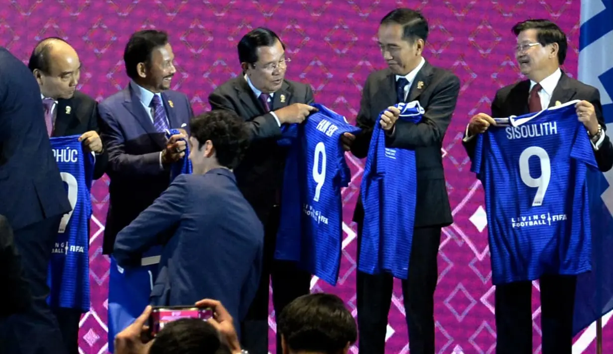 Presiden Joko Widodo (kedua kanan) bersama kepala negara dan kepala pemerintahan negara-negara ASEAN menunjukkan jersey bertuliskan namanya masing-masing usai menyaksikan penandatanganan Nota Kesepahaman antara FIFA dan ASEAN di Bangkok, Thailand, Sabtu (2/11/2019). (Liputan6.com/Biro Pers Setpres)