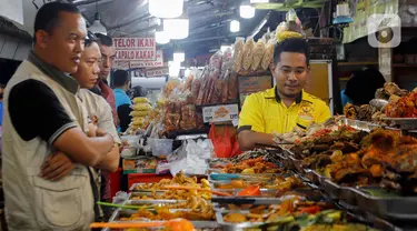 Pengunjung memilih menu berbuka puasa di Sentra Kuliner Nasi Kapau di Jalan Kramat Raya, Senen, Jakarta, Kamis (14/3/2024). (Liputan6.com/Herman Zakharia)