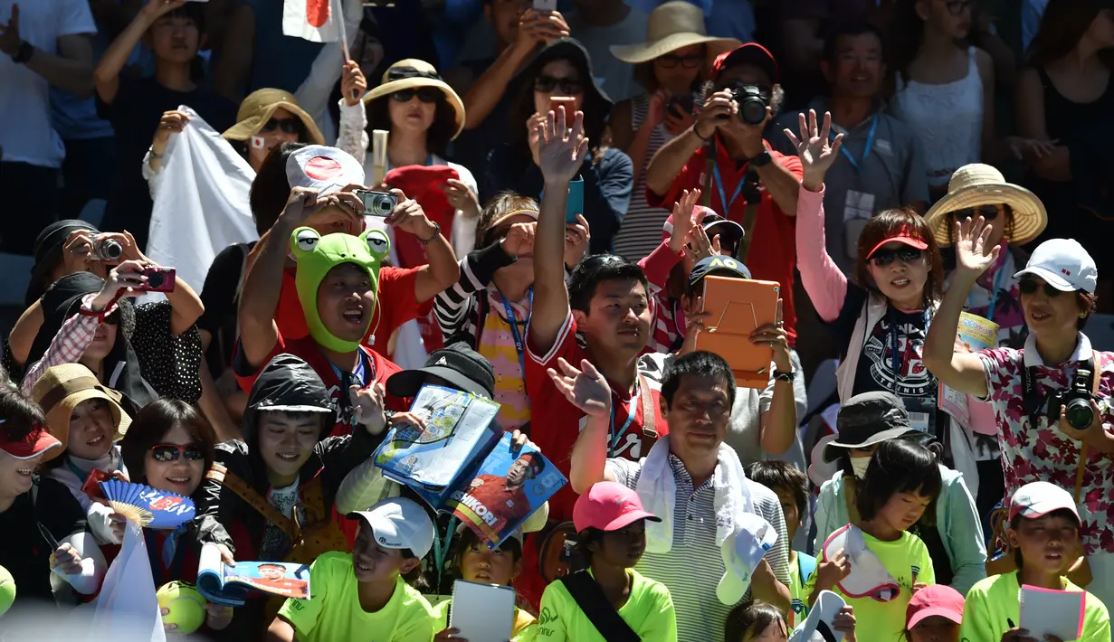 Pendukung dari petenis Jepang, Kei Nishikori merayakan kemenangannya atas Rusia Andrey Kuznetsov setelah pertandingan putaran pertama tunggal putra Australian Open 2017 di Melbourne, Australia (16/1). (AFP Photo/Paul Crock)