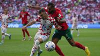 Pemain Timnas Kroasia, Josip Juranovic (kiri) berebut bola dengan pemain Timnas Maroko, Sofiane Boufal dalam laga matchday pertama Grup F Piala Dunia 2022 di Al Bayt Stadium, Qatar, Rabu (23/11/2022) sore WIB. (AP/Thanassis Stavrakis)