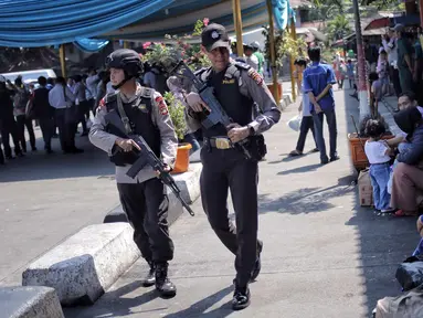 Pasukan Brimob Polda Metro Jaya bersenjata lengkap patroli di Terminal Kampung Rambutan, Jakarta, Selasa (19/6). Penjagaan dilakukan untuk memberi rasa aman kepada pemudik pada arus balik Lebaran 2018. (Liputan6.com/Faizal Fanani)