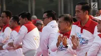 Presiden Joko Widodo bersama Wapres Jusuf Kalla, dan sejumlah pejabat negara menari Poco-Poco dalam rangka pemecahan rekor Guinness World Records di Lapangan Monas, Jakarta, Minggu (5/8). Acara ini diikuti 61 ribu peserta. (Merdeka.com/Iqbal S. Nugroho)