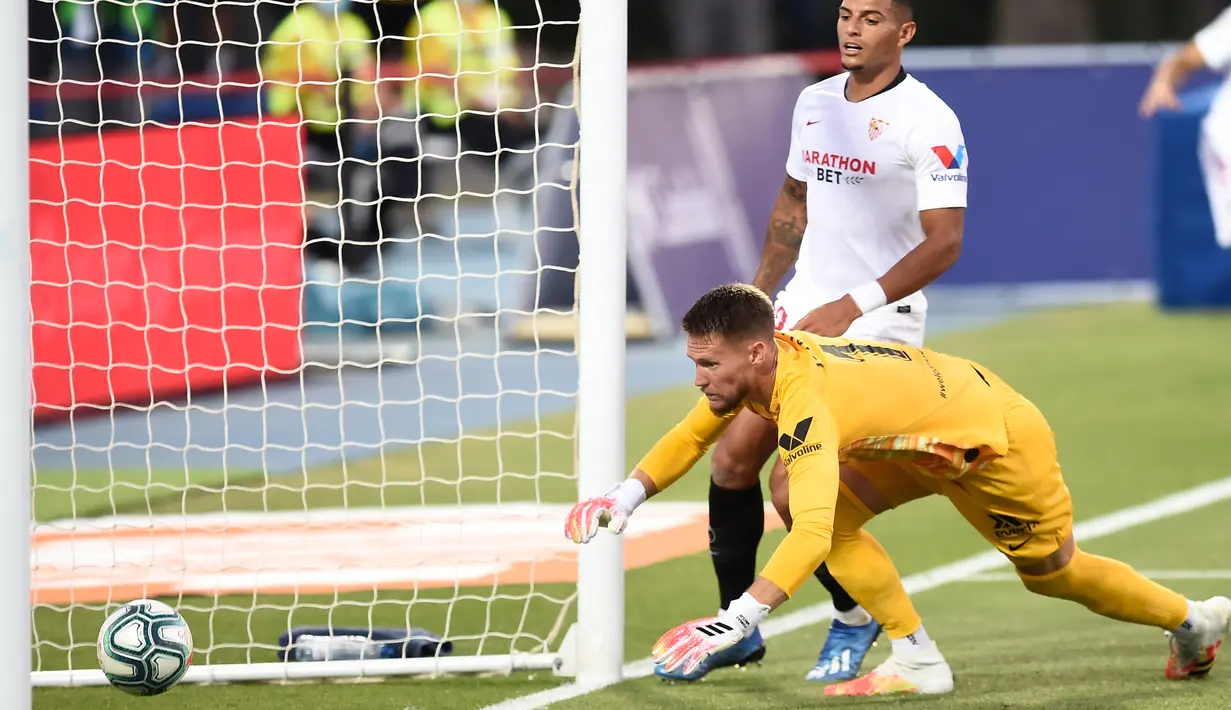 Pemain Sevilla, Diego Carlos, melakukan gol bunuh diri saat melawan Levante pada laga La Liga di Estadio Camilo Cano, Selasa (16/6/2020). Kedua tim bermain imbang 1-1. (AFP/Jose Jordan)