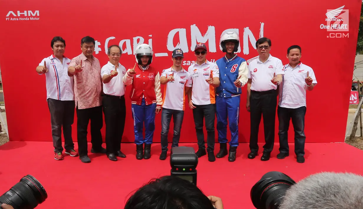 Pembalap MotoGP Marc Marquez (keempat kanan) dan Dani Pedrosa (tengah) berfoto bersama jajaran direksi AHM serta perwakilan SMK dalam acara kampanye keselamatan berkendara di BSD, Tangerang Selatan (10/17).(Liputan6.com/Pool/Bon)