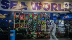 Petugas mengenakan pakaian pelindung menyemprotkan disinfektan area Sea World, Ancol, Jakarta, Sabtu (14/3/2020). Pembersihan Sea World dan Ocean Samudera guna mengantisipasi penyebaran virus corona (Covid-19). (Liputan6.com/Faizal Fanani)