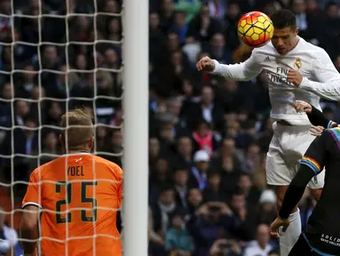 Penyerang Real Madrid, Cristiano Ronaldo (kedua kiri) berusaha menyundul bola kearah kiper Rayo Vallecano pada lanjutan liga Spanyol di Santiago Bernabeu (20/12). Real Madrid menang telak atas Rayo Vallecano dengan skor 10-2. (REUTERS/Sergio Perez)