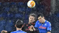 Bek Real Sociedad, Nacho Monreal (tengah) dan penyerang Napoli, Hirving Lozano (kanan) melakukan sundulan pada matchday terakhir Grup F Liga Europa di Diego Armando Maradona, Jumat (11/12/2020) dini hari WIB. Napoli bermain imbang 1-1 melawan Real Sociedad. (Alberto PIZZOLI / AFP)
