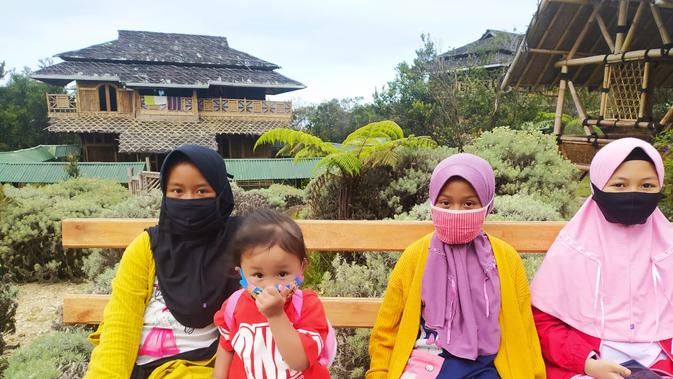 Dengan menggunakan standar kesehatan, beberapa pengunjung anak-anak terlihat menggunakan masker di lokasi TWA Papandayan, Garut, Jawa Barat. (Liputan6.com/Jayadi Supriadin)