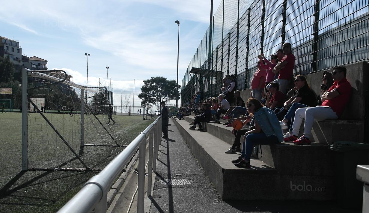 Sejumlah orang tua menonton anaknya berlatih sepak bola di lapangan CF Andorinha di Kawasan San Antonio, Funchal, Portugal. Klub tersebut merupakan tempat awal Cristiano Ronaldo meniti karir sebagai pesepak bola. (Bola.com/Reza Khomaini)