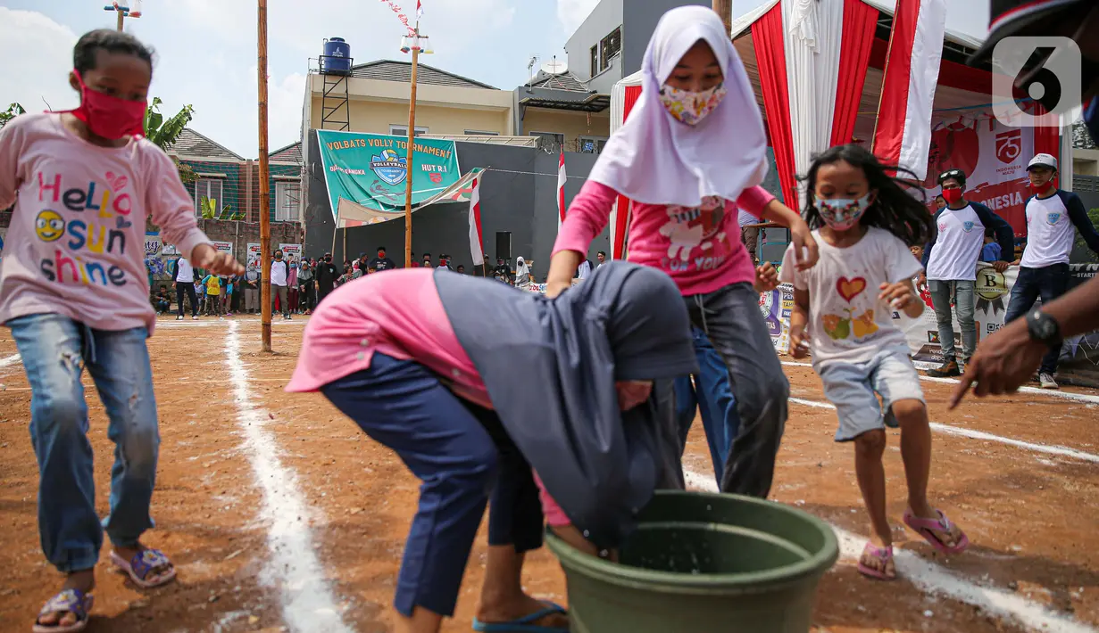 Anak-anak mengikuti lomba menangkap belut dengan menerapkan protokol Kesehatan di kawasan Pondok Cabe IV, Tangerang Selatan, Senin (17/8/2020). Lomba tersebut digelar untuk menyemarakkan HUT ke-75 Kemerdekaan Republik Indonesia. (merdeka.com/Faizal Fanani)