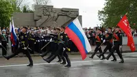 Militer Rusia berparade mengibarkan bendera kebangsaan di ibu kota Moskow (AP)