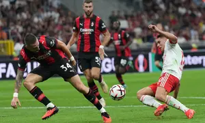 Pemain AC Milan Strahinja Pavlovic berebut bola dengan pemain Benfica Heorhiy Sudakov dalam laga Liga Europa antara AC Milan vs Benfica di Milan, Italia, Rabu, 16 September 2026. (AP Photo/Antonio Calanni)