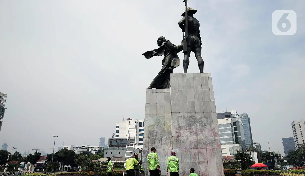 Petugas PPSU DKI Jakarta membersihkan coretan di kawasan Kebon Sirih, Jakarta Pusat, Sabtu (10/10/2020). Dinas kebersihan dari PPSU dan Satpel DLH melakukan penghapusan coretan di fasilitas umum oleh pengunjuk rasa saat demonstrasi tolak Omnibus Law UU Cipta Kerja. (Liputan6.com/Johan Tallo)