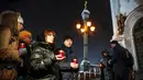 Warga membawa lilin di depan Katedral Kristus Juruselamat Moskow, Rusia, Senin (12/2). Pesawat Saratov Airlines jatuh di hamparan salju. (Maxim ZMEYEV / AFP)